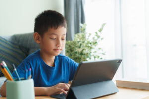 Asian,Boy,Is,Studying,Online,Via,The,Internet,On,Tablet