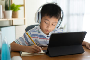 Asian,Boy,Learning,Online,Via,Internet,With,A,Tutor,On